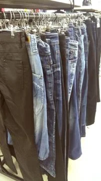 Hangers with different pants. Stock Photos