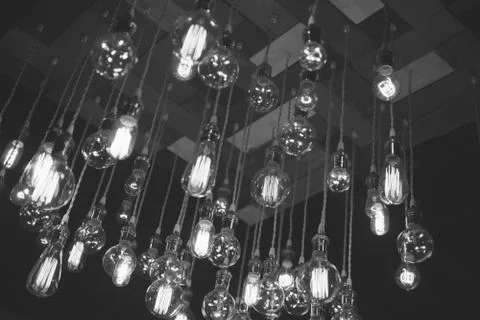 Hanging array of many incandescent light bulbs Stock Photos
