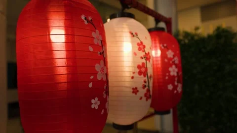 Hanging Asian Paper Lanterns with Cherry Blossom Print at Night Stock Footage 346009524
