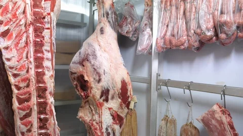 Hanging beef quarters in freezer Stock Footage 89829753