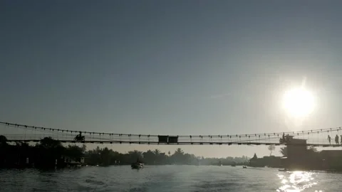 Hanging bridge of Lok Baintan floating market, rear view of moving motor boat Stock Footage 135898927