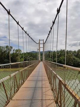 Hanging bridge on a river Stock Photos