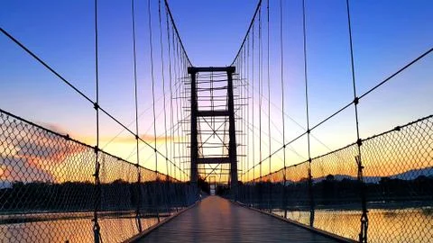 Hanging bridge under construction during beautiful sunset. Stock Photos