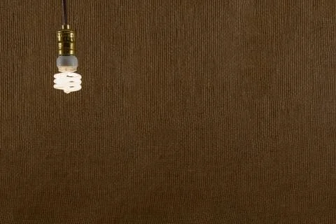 Hanging cfl bulb background Stock Photos