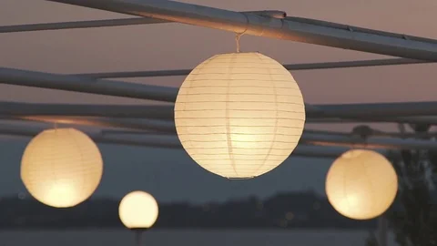 Hanging chinese lanterns lit, decorations at night beach bar 100p. Stock Footage 72552592