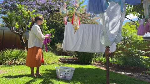 Hanging clean clothes in the backyard Stock-Footage 326021680