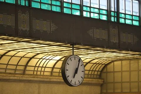 Hanging clock in a station interior Stock Photos