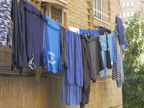 Hanging clothes drying laundry lines in building  Stock Footage 80613769