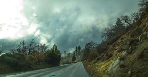 Hanging clouds on a rainy road Stock Photos