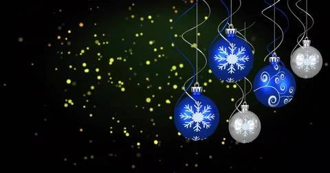Hanging cluster of five snowflake baubles catching shine on right side, with Illustrazione stock
