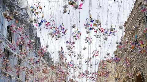 Hanging colored ornaments, lanterns in the wind in the center of Moscow Stock Footage 114213313