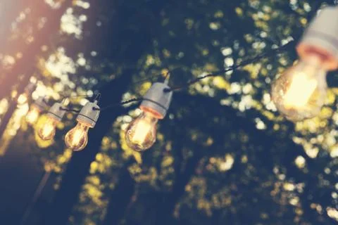 Hanging decorative string lights for outdoor party Stock Photos