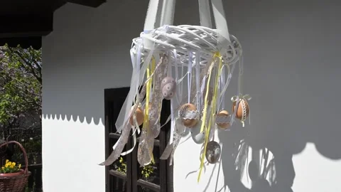 Hanging Easter egg decoration with ribbons on a village house. Stock Footage 332730715