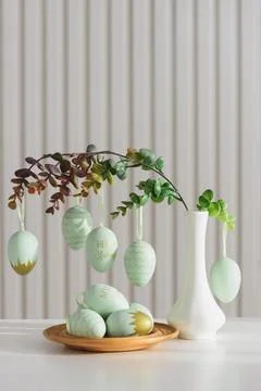 Hanging Easter Eggs and Spring Branches in Vase. Festive Pastel Decor Stock Photos