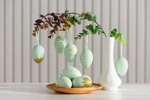 Hanging Easter Eggs and Spring Branches in Vase. Festive Pastel Decor Stock Photos