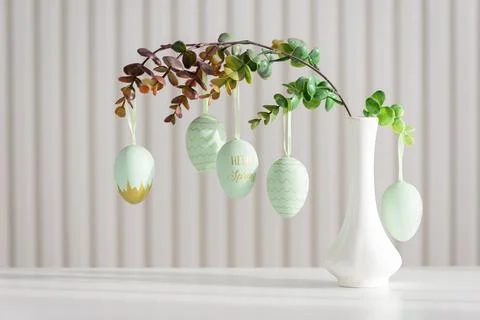 Hanging Easter Eggs and Spring Branches in Vase. Festive Pastel Decor Stock Photos