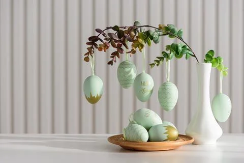 Hanging Easter Eggs and Spring Branches in Vase. Festive Pastel Decor Stock Photos