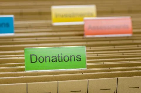 Hanging file folder labeled with donations Stock Photos