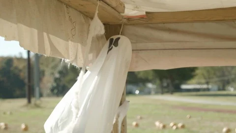 A hanging ghost decoration at a pumpkin patch around Halloween.  Wind Stock Footage 129204627
