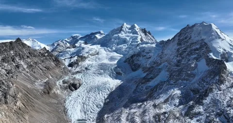 Hanging glacier and snow capped mountain with lake in Tibet, China Stock Footage 309525611