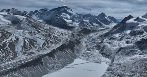 Hanging glacier and snow capped mountain with lake in Tibet, China Stock-Footage 309527670