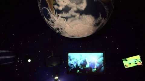 Hanging globe above televisions Stock Footage 84650641