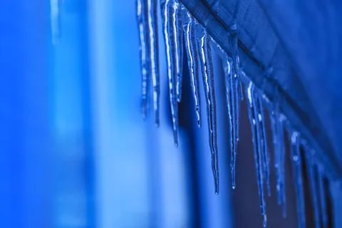Hanging icicle during the spring time. Melting icicles with crystal texture o Stock Photos