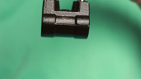 Hanging iron lock in hand Stock Footage 76691060