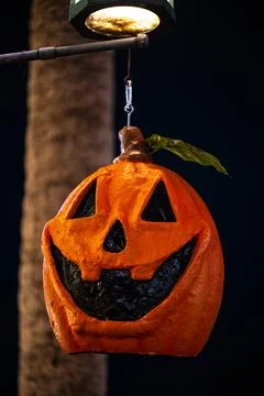 Hanging Jack-O’-Lantern Under Street Light at Night Stock Photos
