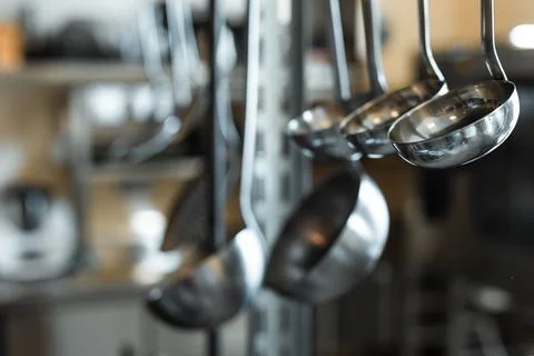 Hanging ladles in the kitchen Foto stock