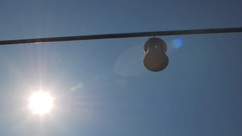 Hanging lantern against a blue sky. solar backlight Stock Footage 107935457