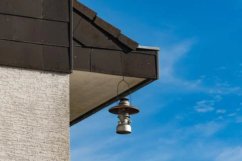 Hanging lantern on building under clear blue sky Stock Photos