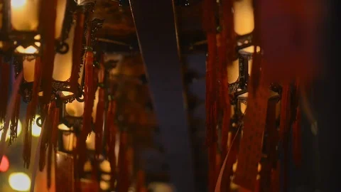 Hanging lanterns with burning lights are in interior of asian temple. 스톡 동영상 120473142