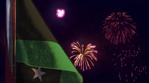 Hanging Libya flag on firework sky bokeh bg Video stock 296870085