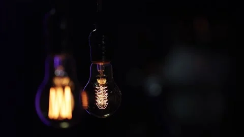 Hanging light bulbs hang in the dark close up. Stock Footage 149196051