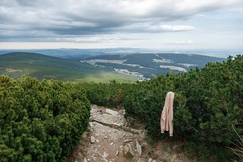 A hanging, lost by someone, beige jacket on a stone path of a tourist route.. Stock Photos