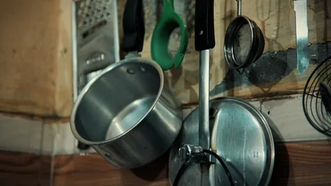 Hanging Metal Kitchen Utensils Including Pots and Pans in a Home Kit, Poor .. Stock Footage 345363607