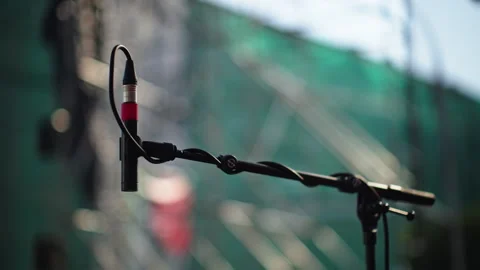Hanging Microphone on Stand at Outdoor Stage with Bokeh Stock Footage 339382565