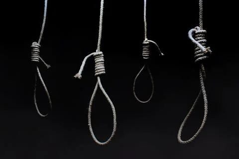Hanging nooses on black background. Stock Photos