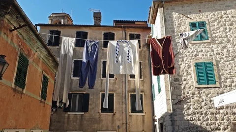 Hanging old clothes waving into medieval scenery in old town in Europe 1 Stock Footage 112242070