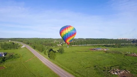 Hanging in one place  bright balloon and  passing train around aerial video Vidéo 80280553