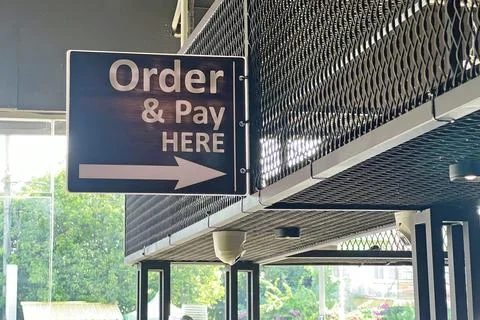 Hanging order and pay here sign board. Stock Photos