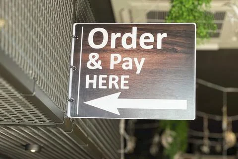 Hanging order and pay here sign board. Stock Photos