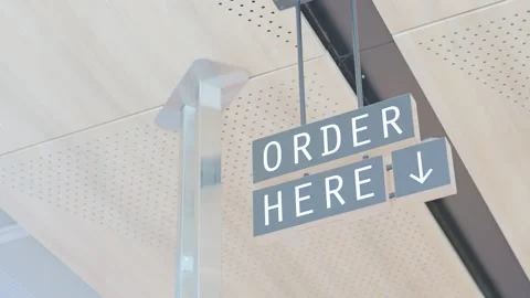 Hanging order here directional sign at restaurant counter Stock Footage 339039475
