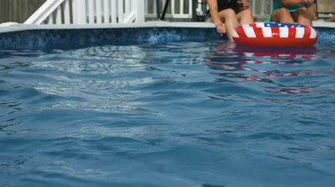 Hanging out at a pool with an american styled float during summer Video stock 64892400