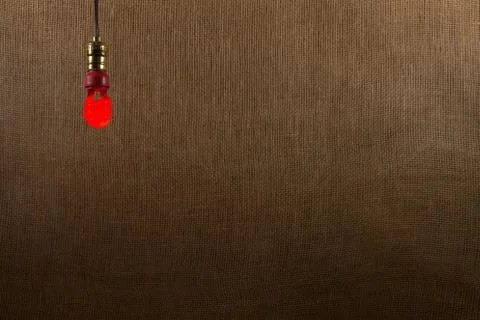 Hanging red cfl bulb background Stock Photos