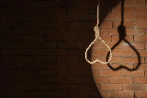 Hanging rope with loop on dark brick background. Suicide concept Stock Photos