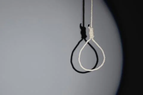 Hanging rope with loop on grey background. Suicide concept Stock Photos
