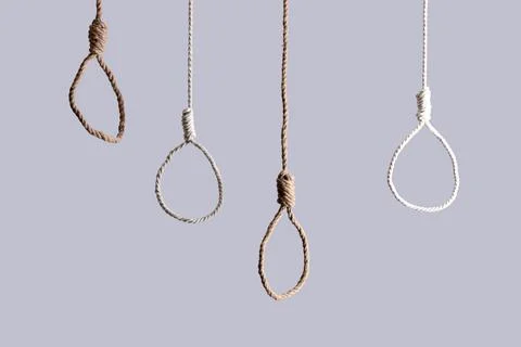 Hanging ropes with loops on light background. Suicide concept Stock Photos