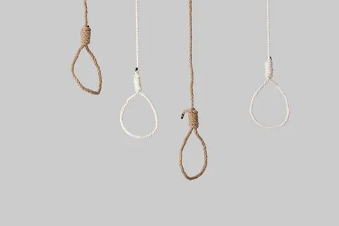 Hanging ropes with loops on light background. Suicide concept Stock Photos